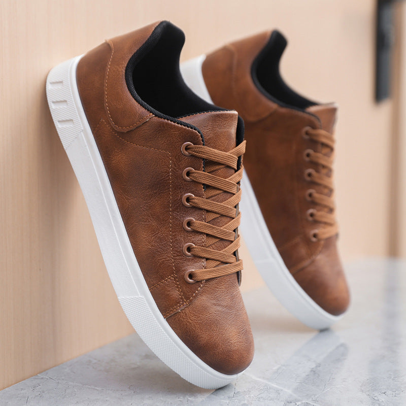 Brown lace-up flat casual shoes with round toe, black collar, and white outsole