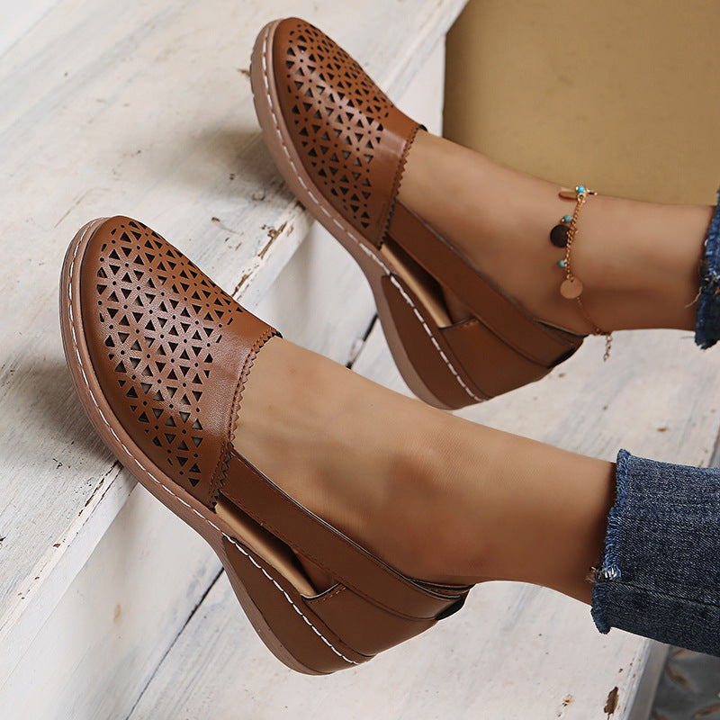 Brown round-toe wedge sandals with laser-cut side panels and ankle strap