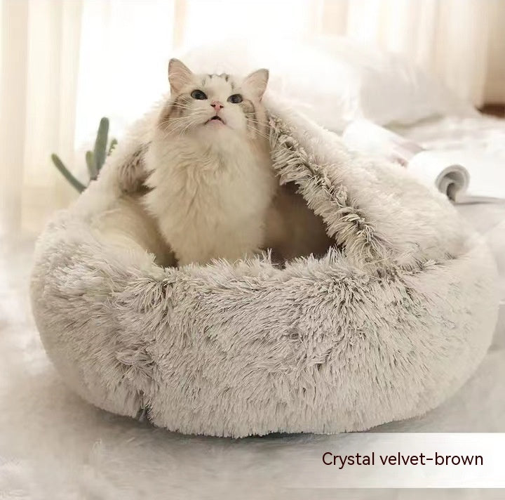 Round plush pet bed in brown plush, cat looking out from the opening