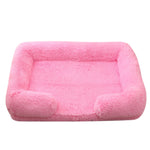 Light pink plush dog bed with padded sides and rounded bolster base