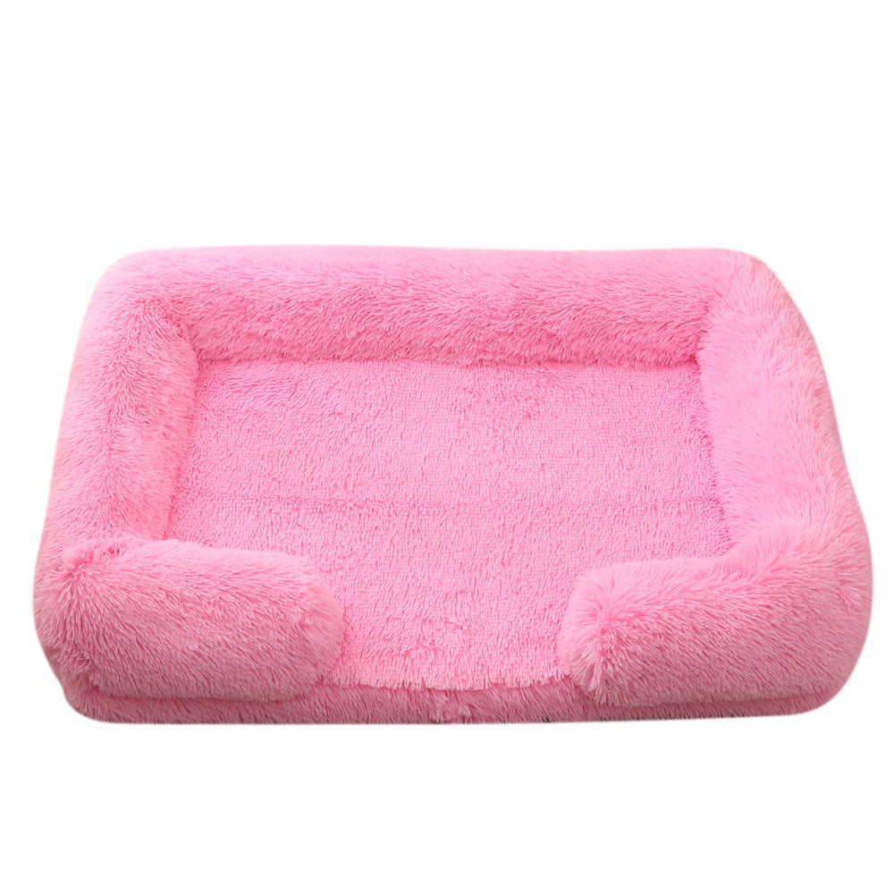 Light pink plush dog bed with padded sides and rounded bolster base
