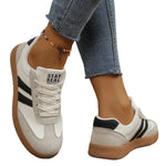 Casual sneakers in cream with black side stripes and tan rubber sole