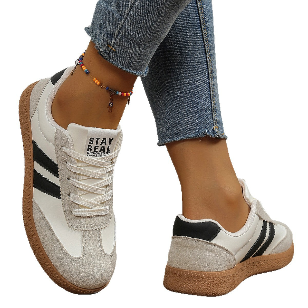 Casual sneakers in cream with black side stripes and tan rubber sole