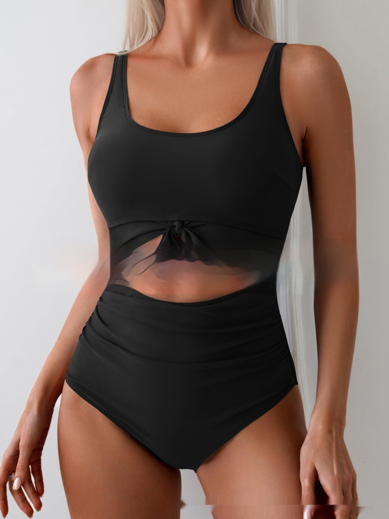 Black one-piece swimsuit with tie-front waist and sheer-look cutout midsection