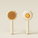 Cream and yellow cat grooming massage brushes with orange button and brown pins