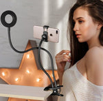 LED selfie ring light with black stand holding a smartphone for lighting