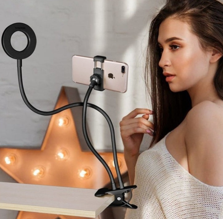 LED selfie ring light with black stand holding a smartphone for lighting