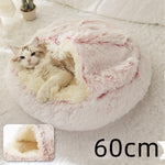Round plush pet bed with pink shag rim and light interior, cat inside.