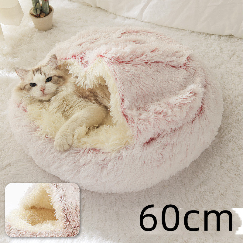 Round plush pet bed with pink shag rim and light interior, cat inside.