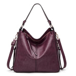 Plum hobo bucket bag with top zipper and dual shoulder straps