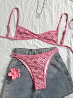 Two-piece bikini set with pink patterned triangle top and matching high-cut bottoms, laid flat