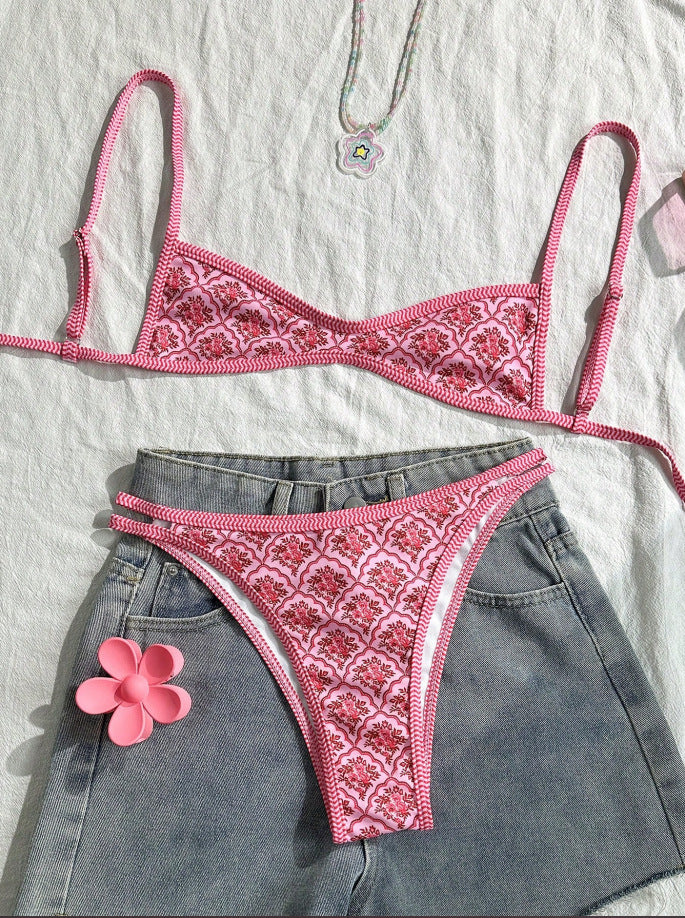 Two-piece bikini set with pink patterned triangle top and matching high-cut bottoms, laid flat