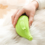 Lime green pet steam brush held against white pet fur for grooming