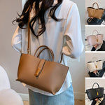 Brown textured PU bucket tote bag with front zipper, top handles, and shoulder strap.
