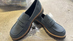 Women’s matte dark gray/blue flat loafer shoes with round toe, buckle strap, and thick tread sole