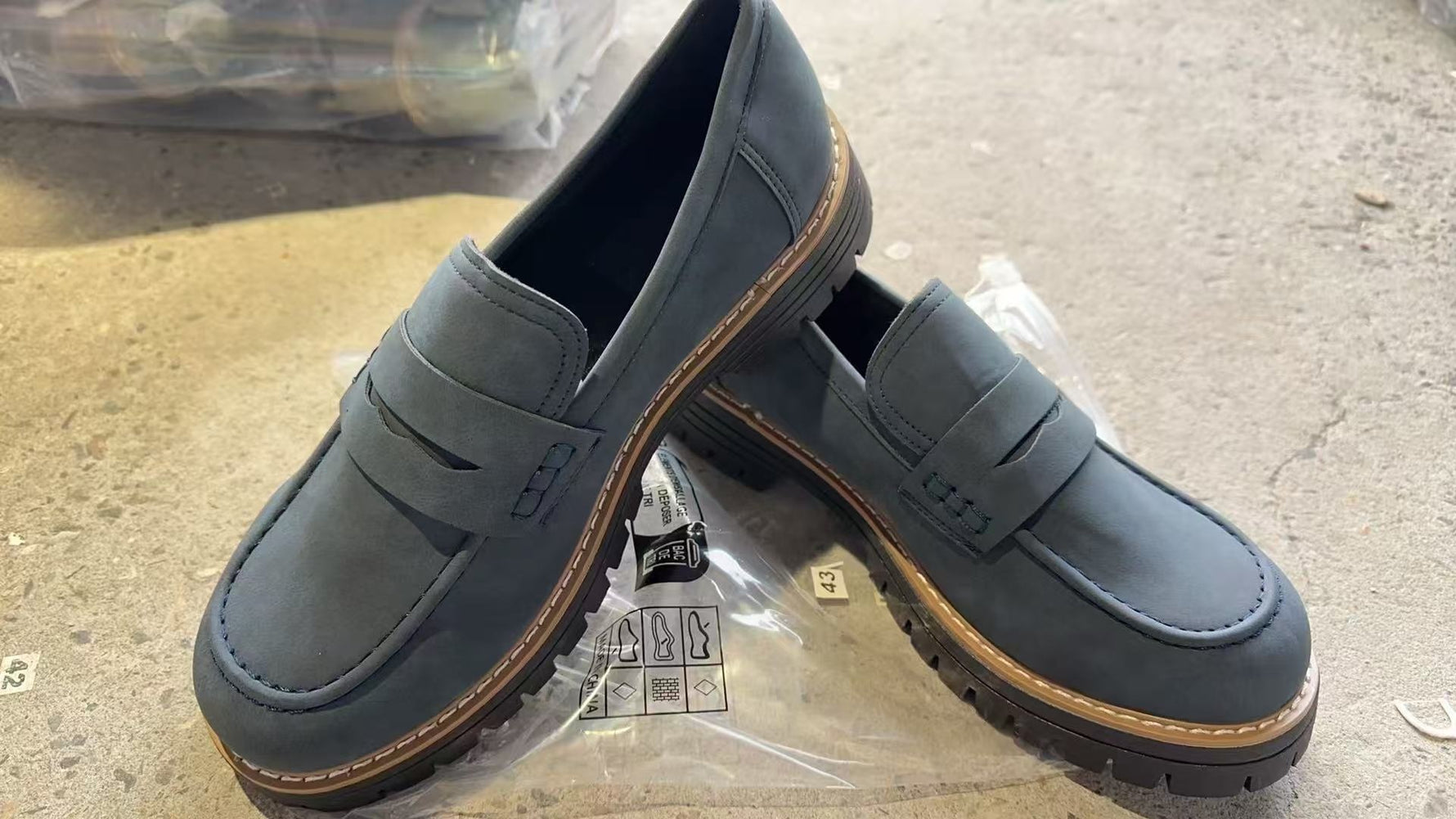 Women’s matte dark gray/blue flat loafer shoes with round toe, buckle strap, and thick tread sole