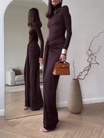 Dark brown long-sleeve maxi dress with draped waist and leg-opening side slit