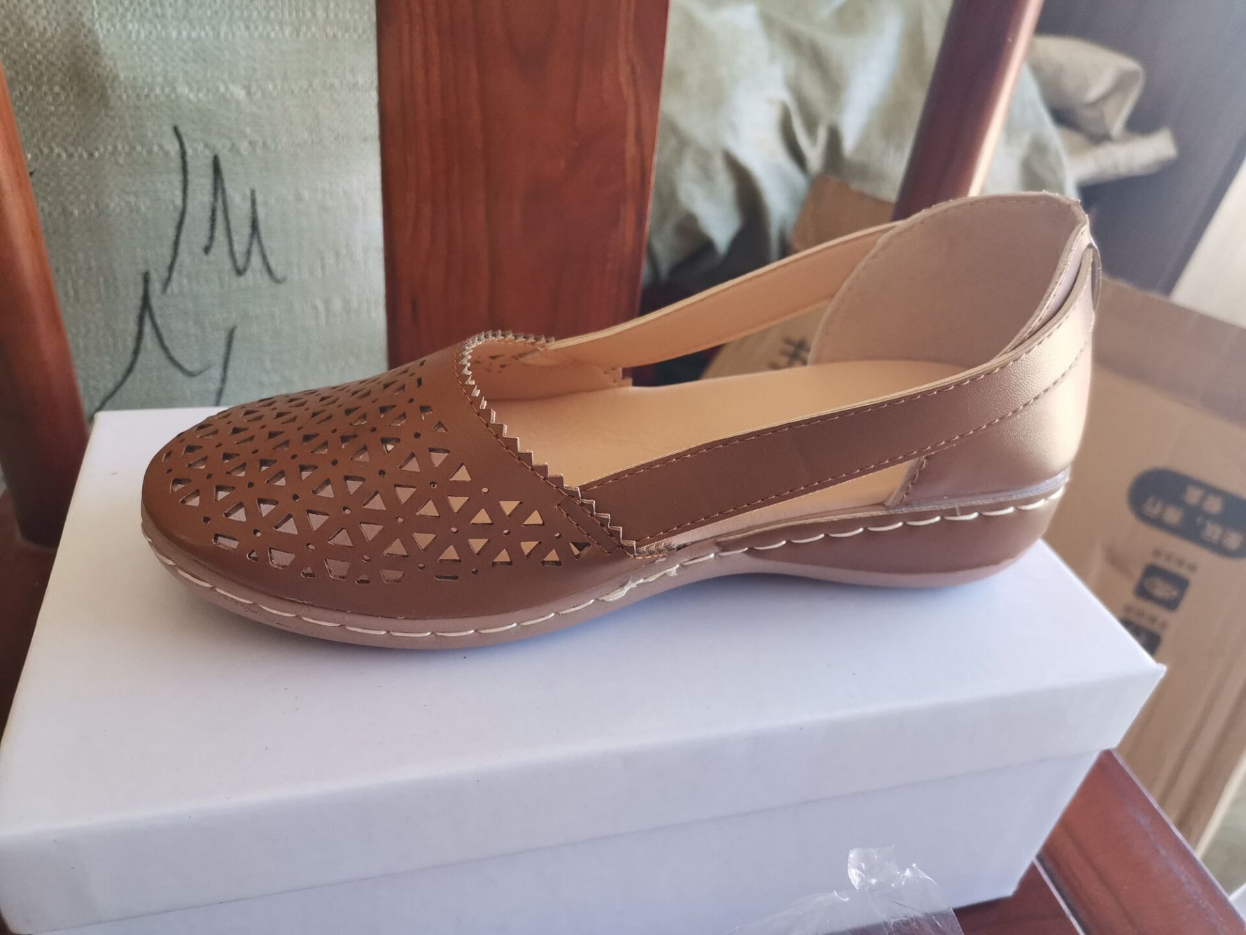Brown perforated women's wedge sandals with round toe and sling strap