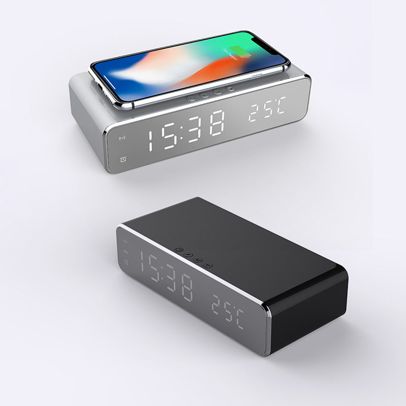 Digital alarm clock with wireless charger, gray and black bases, smartphone on top