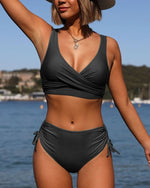Black strappy bikini swimsuit with crossover V-neck top and side-tie ruched bottoms