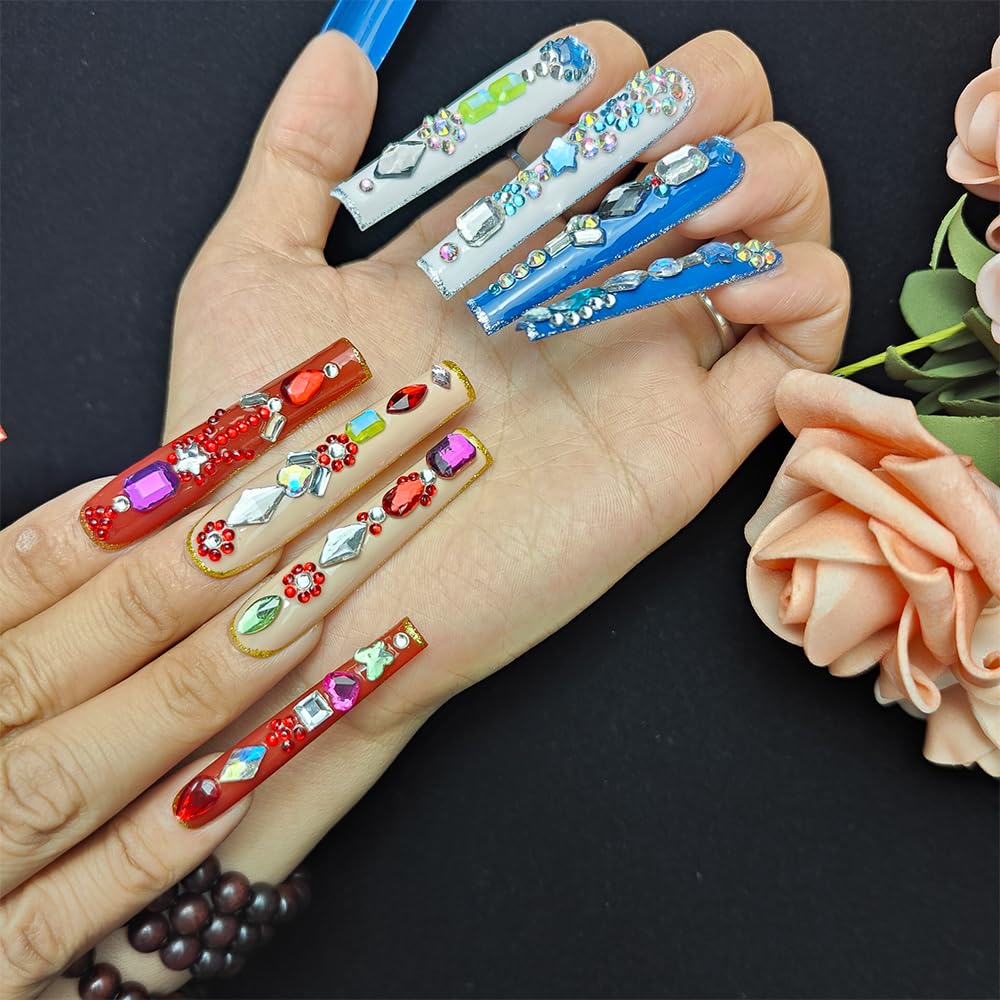 Long press-on nails on hand: red, blue, green and purple gem designs with glossy shine