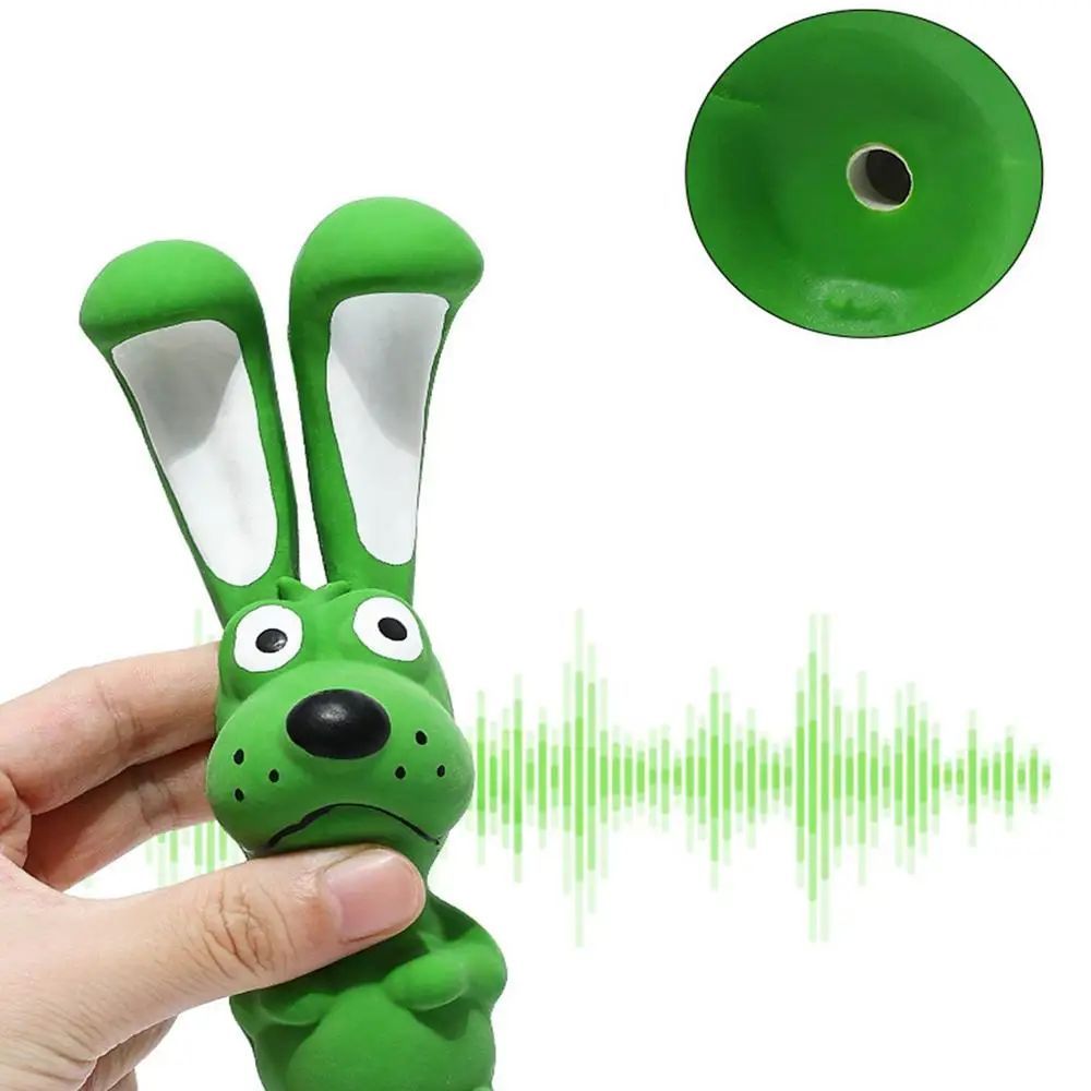 Green latex rabbit squeaky chew toy with white inner ears, held in hand