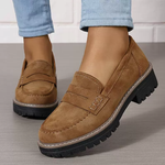 Women’s matte tan flat loafer shoes with round toe, buckle strap, and thick tread sole
