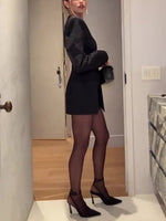 Black double-breasted mini blazer dress with long sleeves and high neckline, side view