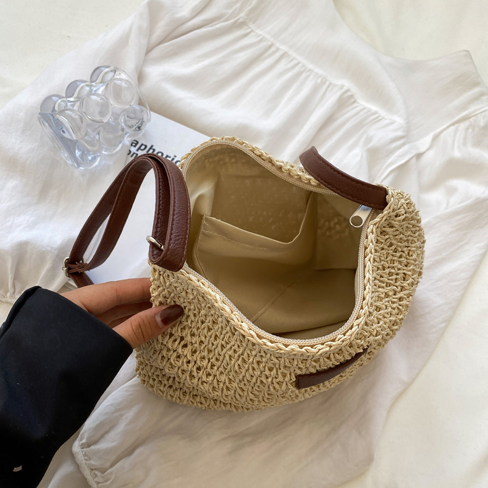 Woven straw shoulder tote with zipper top and dark brown trim, open interior visible
