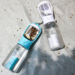 Portable dog water bottle set: blue and white units with cup lids on a surface