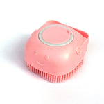 Pink silicone pet bath massage brush with short red bristle rows and gray control ring