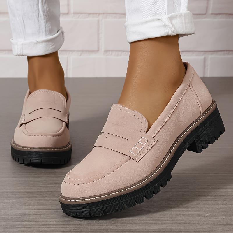 Light pink round-toe flat loafers with buckle strap and black lug sole