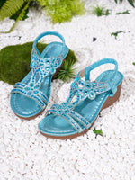 Blue wedge sandals with jeweled floral straps and elastic ankle band, open toe