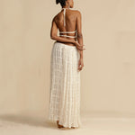 White backless halter crop top with tie straps and tiered pleated maxi skirt