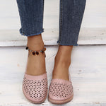 Blush pink round-toe wedge sandals with laser-cut upper and ankle strap