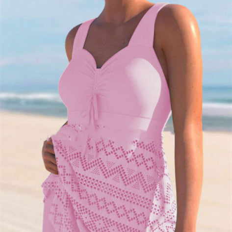 Light pink lace one-piece swimsuit with padded cups, tie-front detail, and patterned lace skirt