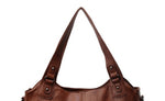 Brown PU handbag with two top handles and round metal strap details