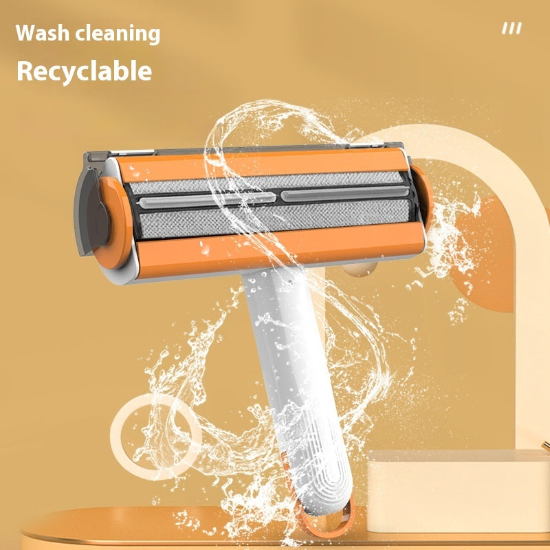 Washable lint roller with orange core, white handle, and water-spray effect