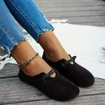 Black suede round-toe flat lace-up shoes on model with tied bow at vamp