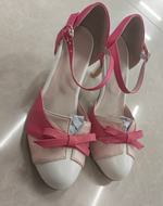 Women’s high heel pumps with pointed toe and bow straps, pink and white color block.
