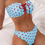 Light blue printed tube-top bikini with red hearts, tie-front drawstring, scalloped high-waist briefs