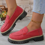 Red round-toe flat loafers with buckle strap and black lug sole