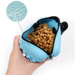 Blue silicone treat pouch with zipper top, open to show dog treats inside