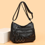 Black PU leather crossbody bag with multiple zippered compartments and braided front pocket