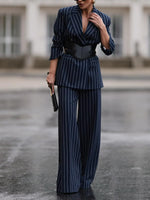 Navy pinstripe blazer and high-waist wide-leg pants with black waist belt