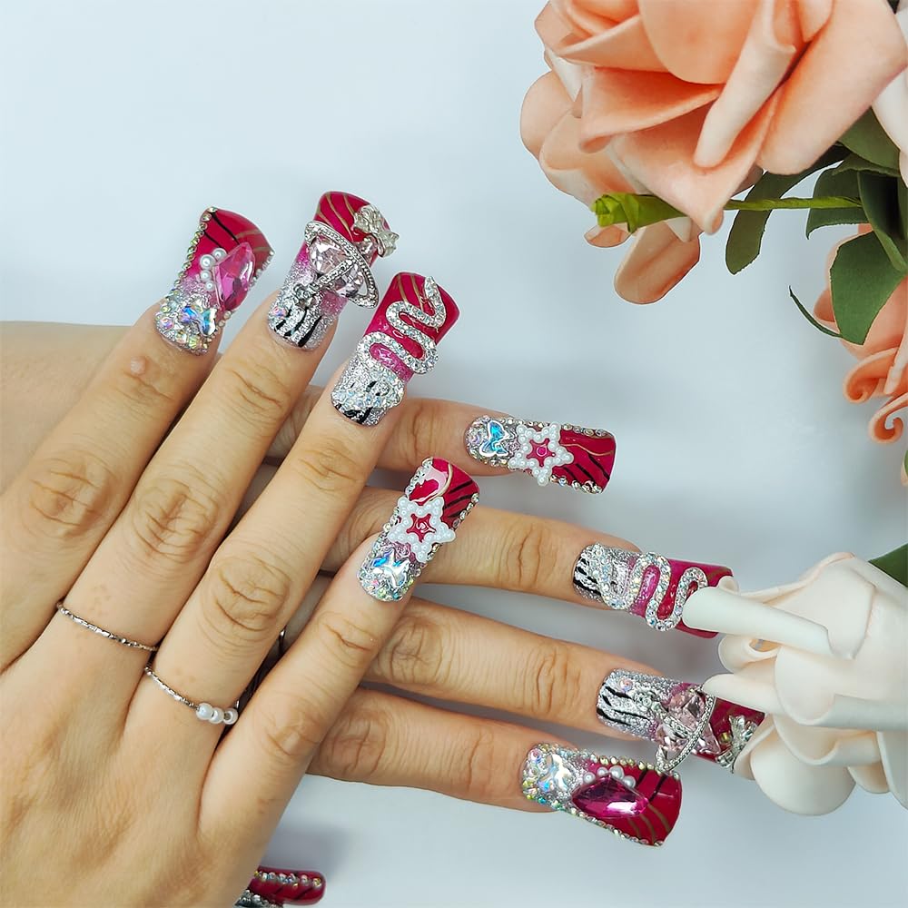 Medium square nails on hands with red and silver glitter tips, rhinestones, stars and heart accents