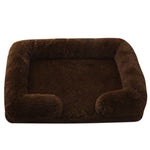 Brown plush dog bed with padded sides and rounded bolster base