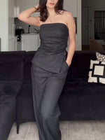 Striped tube top and high-waist trousers set in dark pinstripe, strapless peplum-style drape