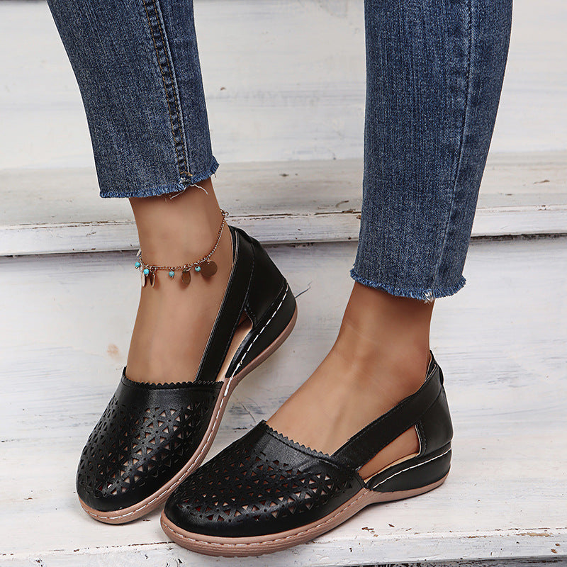 Black perforated women's wedge sandals with round toe and sling strap