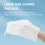 Disposable face towel sheet, white, waffle-textured, held on a hand